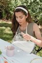 Woman in Sleeveless Shirt Pouring Milk