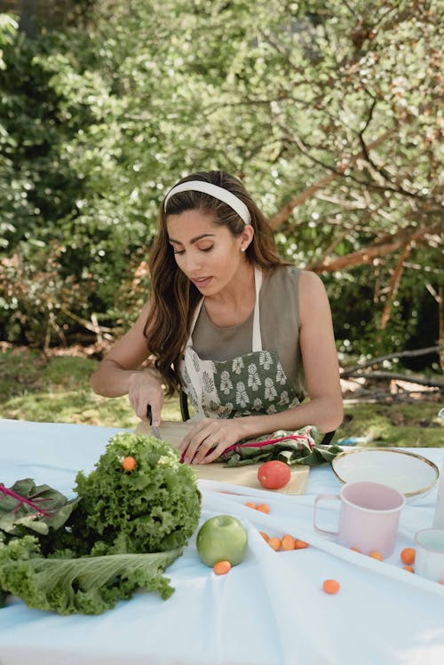 A Woman Slicing a Vegetable