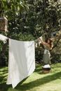 A Woman Hanging Laundry on a Clothes Line