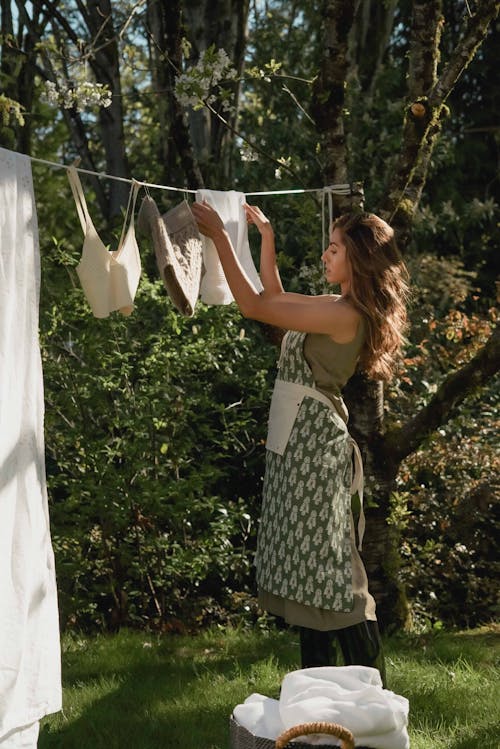 Free A Woman Hanging Clothes Stock Photo