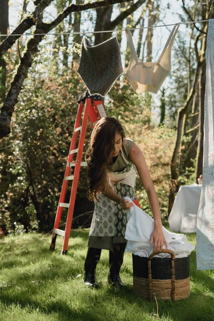 Woman Hanging Laundry In Outdoors