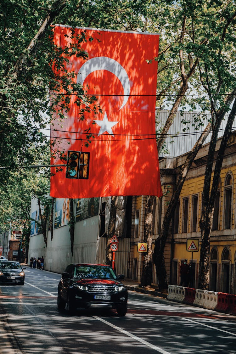 Car Passing A Hanging Turkish Flag