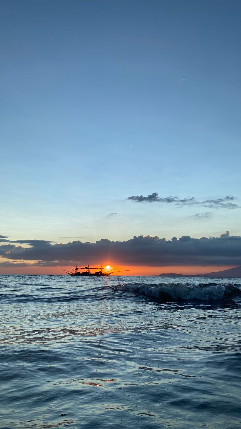A Boat at Sea during Sunset · Free Stock Photo
