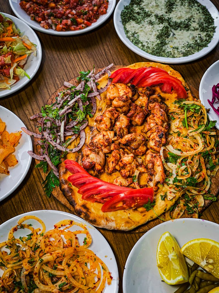 Variety Of Cooked Food On Wooden Table