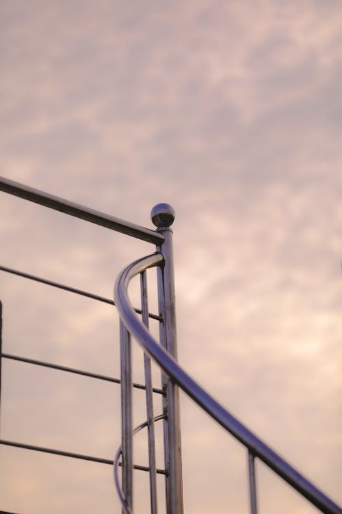 Free Metal railing against cloudy sky Stock Photo