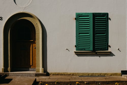 Green Window Near Arch Doorway