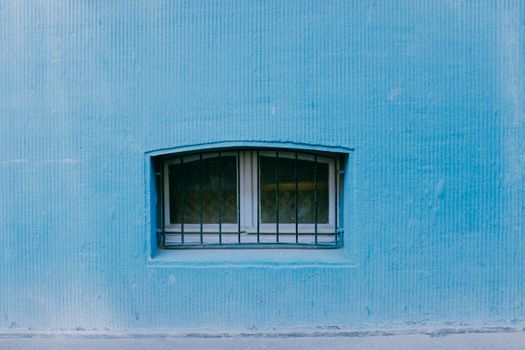 Blue Wall with a Barred Window