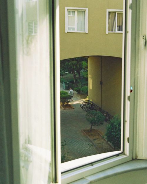 Free A serene view from an open window of a residential courtyard in İstanbul. Stock Photo