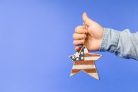 Person Holding Brown and Yellow Star Paper