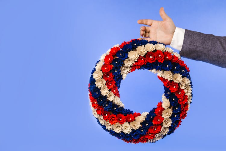 A Hand Holding Colorful Flower Wreath