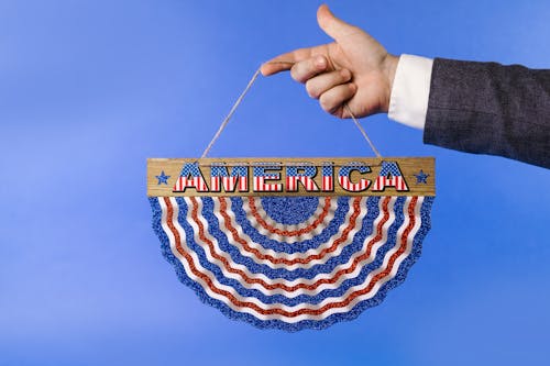 A Person Holding a Colorful Hanging Decoration