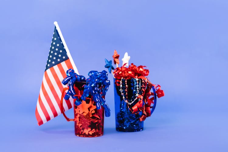 American Flag With Confetti In Red And Blue Plastic Cups