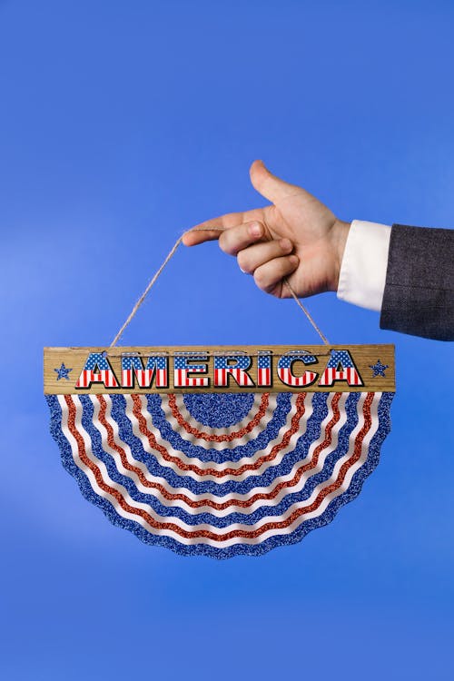 Person Holding a Multicolored Hanging Decoration