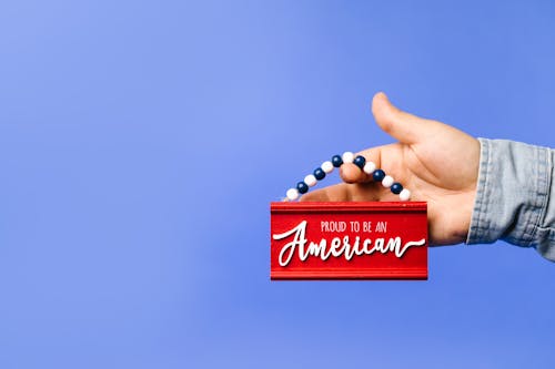 Person Holding a Hanging Decoration With Message