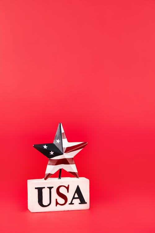 A Star with Stars and  Stripes on a White Pedestal with a Text 