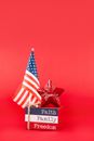 A Miniature American Flag and a Striped Wooden Block
