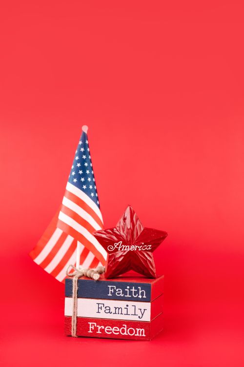 Free American flag and decorative blocks with 'Faith, Family, Freedom' on red background. Stock Photo