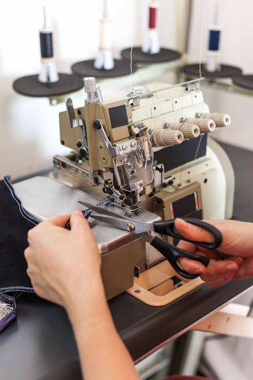 A Seamstress Cutting a Fabric 