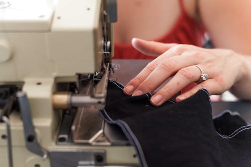 A Person Using a Sewing Machine · Free Stock Photo