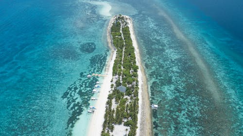 Aerial View of an Island Beach With Clear Blue Waters