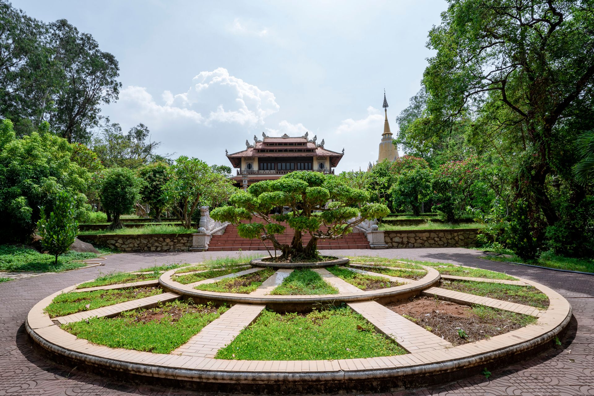A tranquil Buddhist temple surrounded by lush gardens and bonsai trees, perfect for meditation.