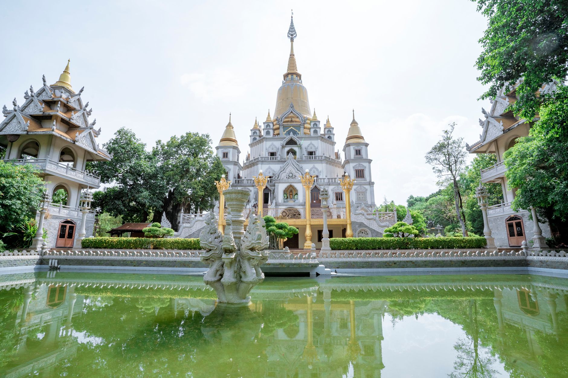 A stunning view of Buu Long Temple in Ho Chi Minh City, reflecting in a serene pond.