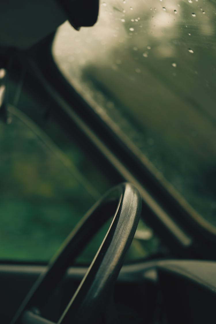 Car Wheel Near Wet Window With Drops