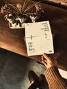 A Person Holding a Page of a Table Calendar