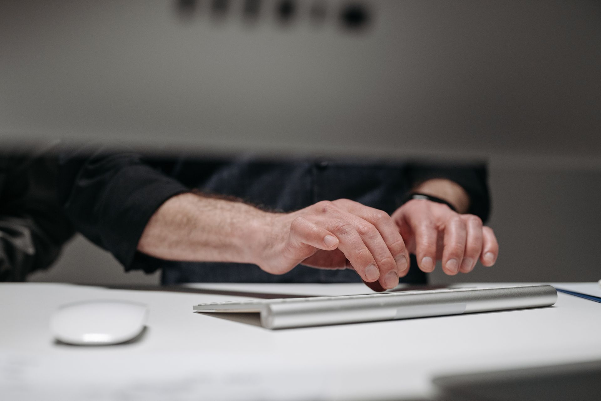 Hands of a Man Typing on Keyboard