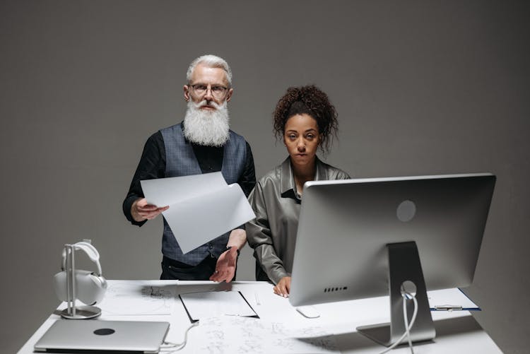 A Bearded Man Holding A Document