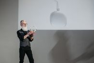 Man in Black Suit Holding Magnifying Glass