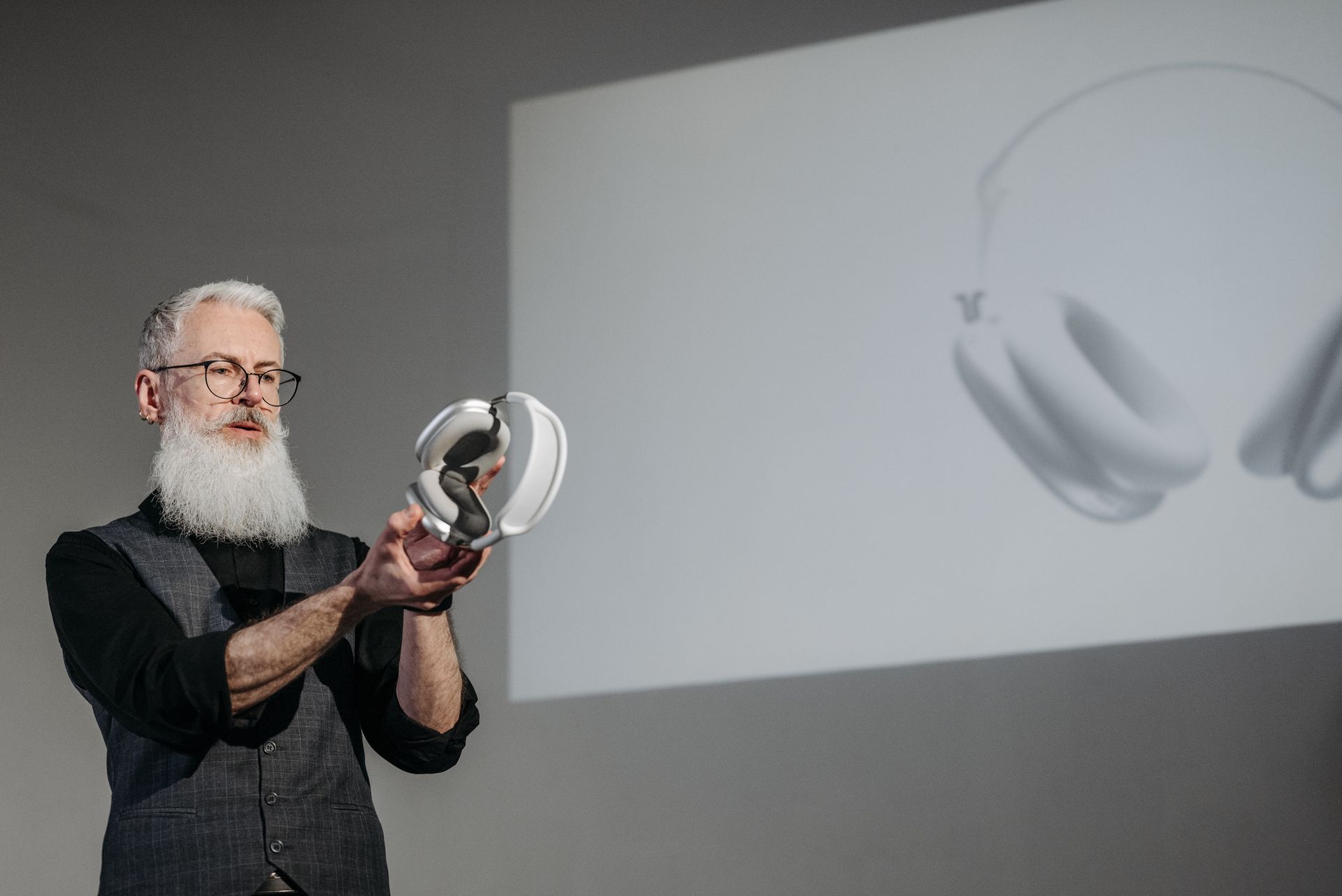 A Man Doing a Presentation while Holding a Wireless Headphones