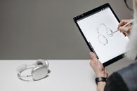 Person Holding Black Ipad Near White Ceramic Mug