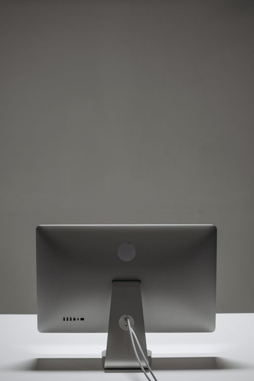 Back View of a Monitor on White Surface · Free Stock Photo
