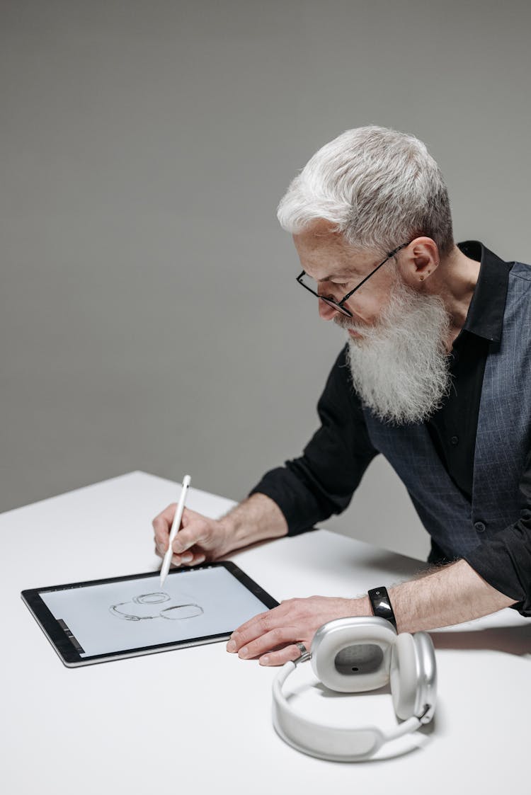 Senior Man Using Digital Drawing On A Tablet