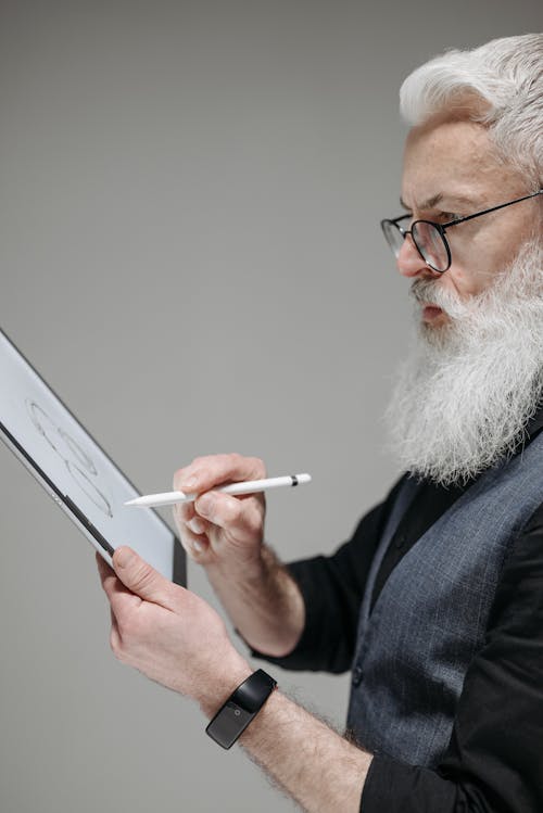 An Elderly Man using a Tablet and Stylus Pen