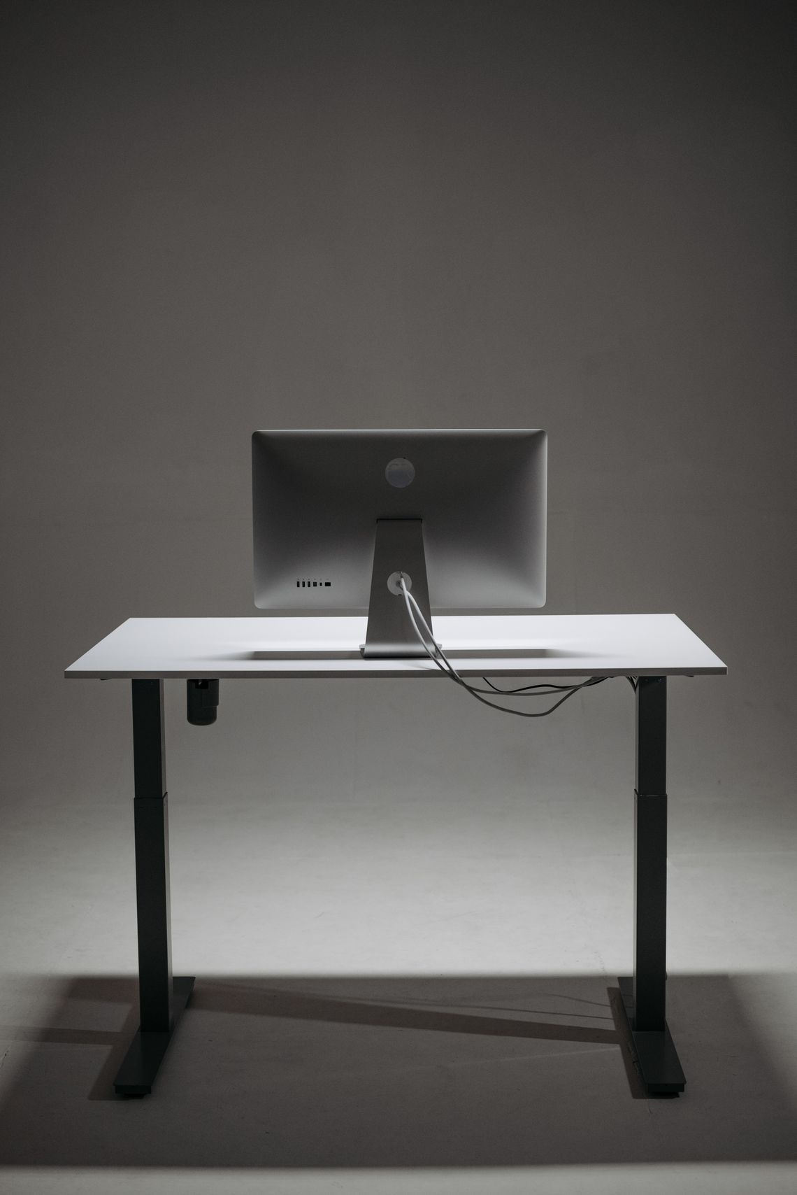 Monitor positioned on a height adjustable standing desk