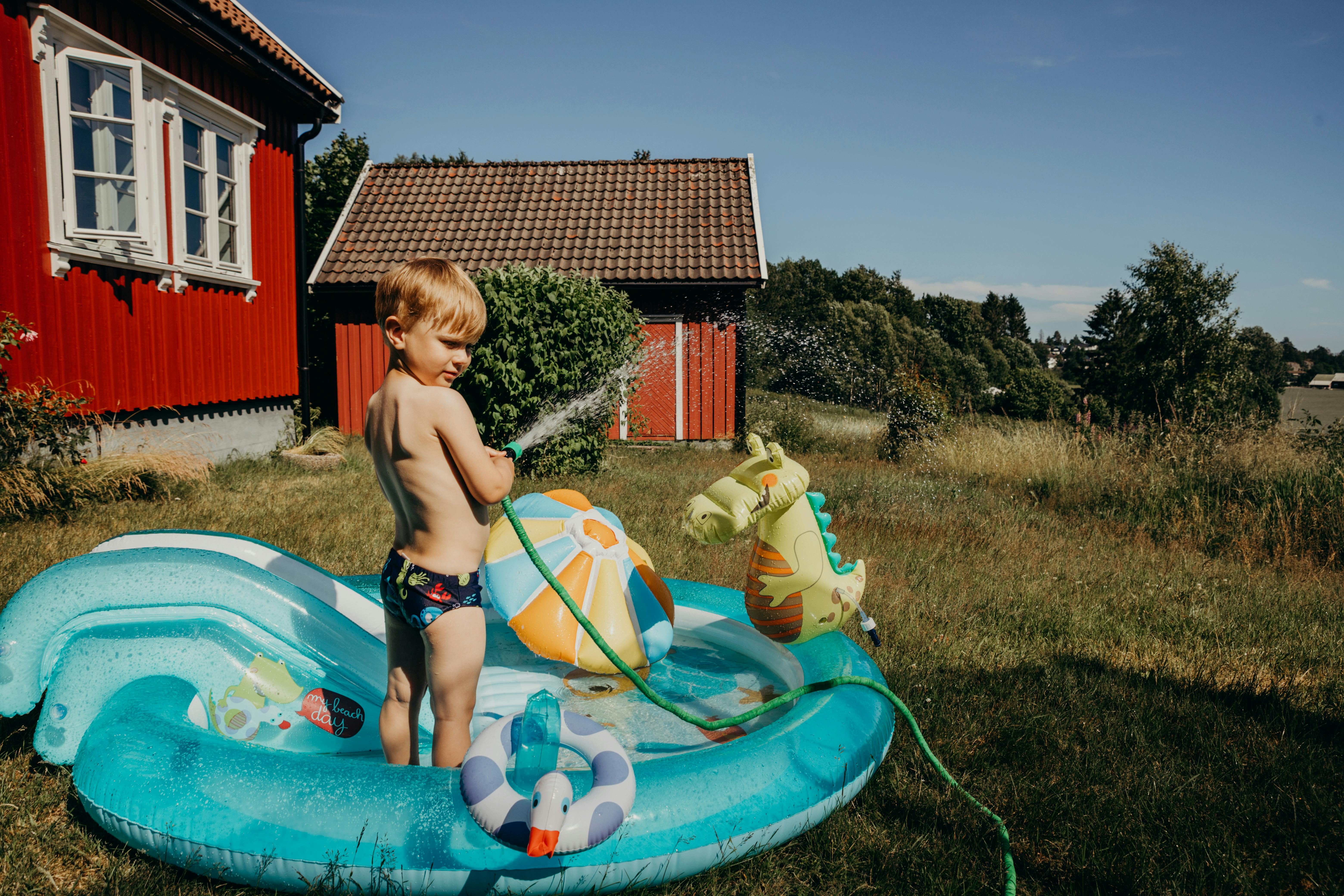 a young boy swimming in a pool