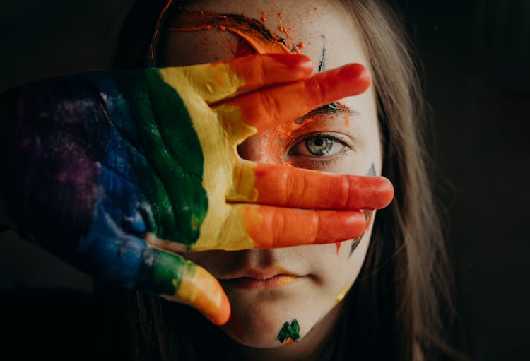 A Girl With A Painted Hand And Face