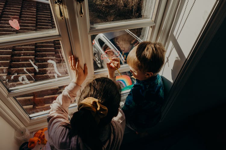 Children Painting On A Glass Window