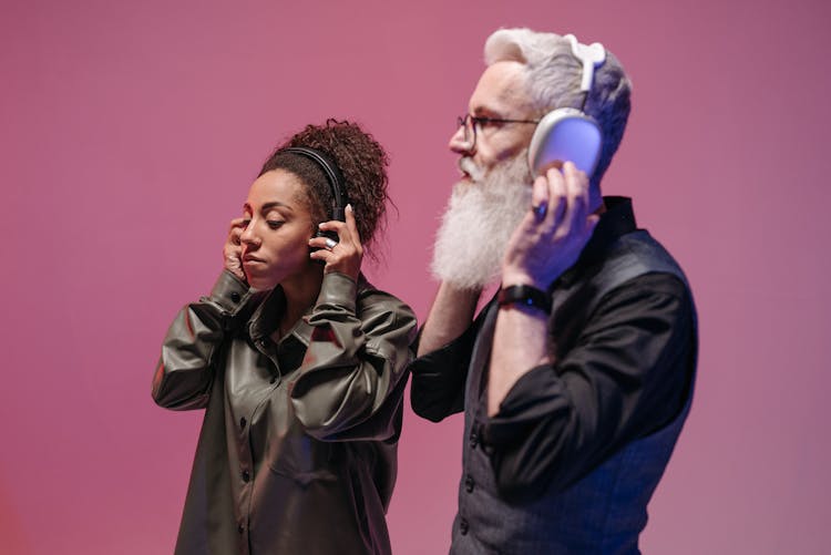 Woman And Man In Black Long Sleeves Wearing Headphones