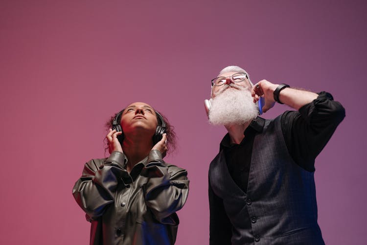 A Man And A Woman Wearing Wireless Headphones