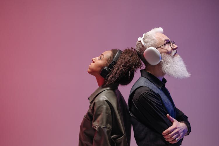 A Man And A Woman Wearing Wireless Headphones