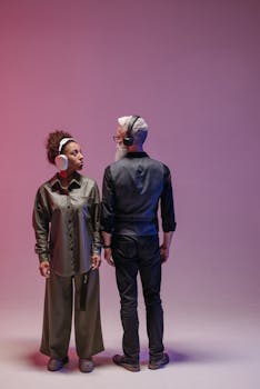 A diverse pair wearing wireless headphones in a conceptual studio setting.