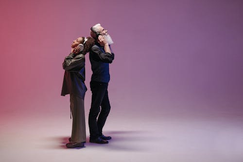 A Man and a Woman using Wireless Headphones