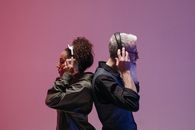 Man and Woman Holding Headphones on their Heads