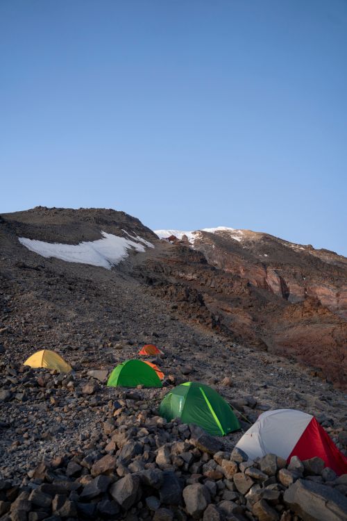 Free Serene mountain camping scene with tents and rocky landscape in Karagüney, Turkey. Stock Photo