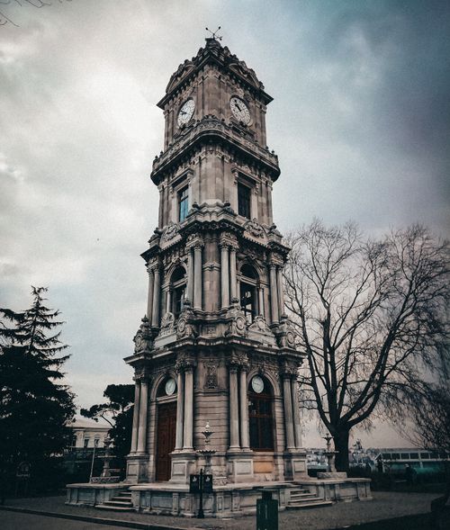 Free Majestic view of the Dolmabahçe Clock Tower under moody skies in İstanbul, Türkiye. Stock Photo