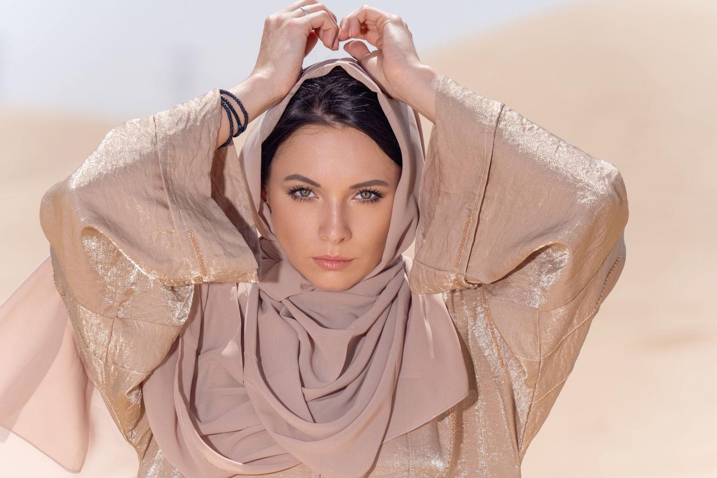 Woman in a flowing brown abaya, elegant Arabian fashion portrait