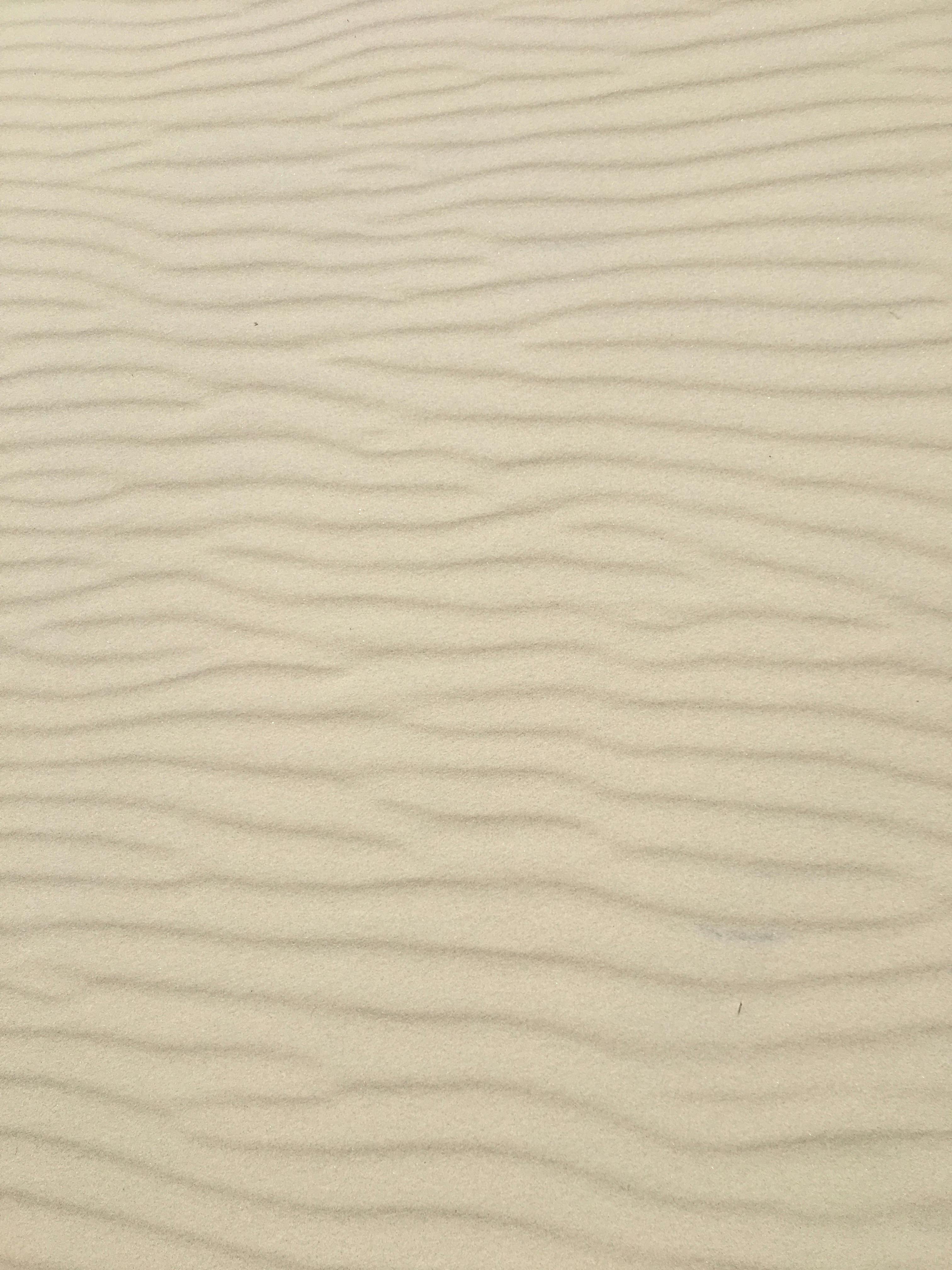 Close-up of wavy sand patterns in Łeba, Poland's desert-like landscape.